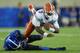 LEXINGTON, KY - SEPTEMBER 28: Tyler Murphy #3 of the Florida Gators runs with the ball while defended by Nate Willis #21 of the Kentucky Wildcats during the game at Commonwealth Stadium on September 28, 2013 in Lexington, Kentucky. (Photo by Andy Lyon