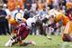 KNOXVILLE, TN - OCTOBER 19: Mike Davis #28 of the South Carolina Gamecocks gets tackled behind the line of scrimmage by A.J. Johnson #45 and Brent Brewer #17 of the Tennessee Volunteers during the game at Neyland Stadium on October 19, 2013 in Knoxville,