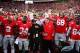 Oct 19, 2013; Columbus, OH, USA; Ohio State Buckeyes running back Carlos Hyde (34), Shelley Meyer and Urban Meyer celebrate after defeating Iowa Hawkeyes 34-24 at Ohio Stadium. Mandatory Credit: Andrew Weber-USA TODAY Sports