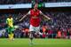 LONDON, ENGLAND - OCTOBER 19: Mesut Oezil of Arsenal celebrates as he scores their second goal during the Barclays Premier League match between Arsenal and Norwich City at Emirates Stadium on October 19, 2013 in London, England. (Photo by Paul Gilham/Ge