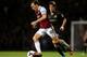 LONDON, ENGLAND - OCTOBER 19: Mark Noble of West Ham is pursued by David Silva of Manchester City during the Barclays Premier League match between West Ham United and Manchester City at Boleyn Ground on October 19, 2013 in London, England. (Photo by War
