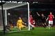 LONDON, ENGLAND - FEBRUARY 19: Wojciech Szczesny of Arsenal scrambles in vain to prevent the ball crossing the line as goalscorer Mario Mandzukic of Bayern Muenchen watches from inside the goal during the UEFA Champions League round of 16 first leg match