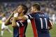 Sep 21, 2013; Foxborough, MA, USA; New England Revolution midfielder Diego Fagundez (14) kisses the crowd while being hugged by midfielder Kelyn Rowe (11) after scoring a goal against D.C. United during the second half at Gillette Stadium. The New Englan