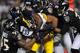 BALTIMORE, MD - DECEMBER 02: Running back Isaac Redman #33 of the Pittsburgh Steelers is pulled down by a pack of Baltimore Ravens defenders in the third quarter at M&T Bank Stadium on December 2, 2012 in Baltimore, Maryland. The Pittsburgh Steelers won,