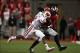 Sep 28, 2013; Columbus, OH, USA; Wisconsin Badgers cornerback Sojourn Shelton (8) tries to tackle Ohio State Buckeyes quarterback Braxton Miller (5) during the fourth quarter at Ohio Stadium. Buckeyes beat the Badgers 31-24. Mandatory Credit: Raj Mehta-US