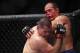 Oct 19, 2013; Houston, TX, USA; Cain Velasquez (red gloves) fights against Junior Dos Santos (blue gloves) in the world heavyweight championship bout during UFC 166 at Toyota Center. Mandatory Credit: Andrew Richardson-USA TODAY Sports