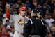 Oct 23, 2013; Boston, MA, USA; St. Louis Cardinals manager Mike Matheny (left) argues with the umpires after Boston Red Sox second baseman Dustin Pedroia (not pictured) was ruled safe at second base on a fielder's choice ground ball in the first inning du