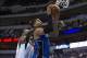 Oct 14, 2013; Dallas, TX, USA; Orlando Magic small forward Tobias Harris (12) is fouled by Dallas Mavericks center Fab Melo (14) during the second half at American Airlines Center. The Magic defeated the Mavericks 102-94. Mandatory Credit: Jerome Miron-US