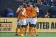Oct 27, 2013; Washington, DC, USA; Houston Dynamo midfielder Giles Barnes (center) is congratulated by teammates after scoring a goal against the against the DC United during the first half at Robert F. Kennedy Memorial. Mandatory Credit: Brad Mills-USA T