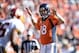 Oct 27, 2013; Denver, CO, USA; Denver Broncos quarterback Peyton Manning (18) attempts to quiet down the crownd in the first quarter against the Washington Redskins at Sports Authority Field at Mile High. Mandatory Credit: Ron Chenoy-USA TODAY Sports