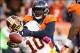 Oct 27, 2013; Denver, CO, USA; Washington Redskins quarterback Robert Griffin III (10) throws the ball away as he's hit by Denver Broncos linebacker Von Miller (58) during the second half at Sports Authority Field at Mile High. The Broncos won 45-21. Mand