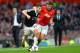 MANCHESTER, ENGLAND - OCTOBER 19: Adam Lallana of Southampton is challenged by Michael Carrick of Manchester United challenges during the Barclays Premier League match between Manchester United and Southampton at Old Trafford on October 19, 2013 in Manch