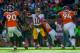 DENVER, CO - OCTOBER 27: Quarterback Robert Griffin III #10 of the Washington Redskins looks to avoid a tackle by Denver Broncos defensive players as he is hit by outside linebacker Danny Trevathan #59 of the Denver Broncos during a game at Sports Author