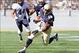 Oct 26, 2013; Annapolis, MD, USA; Navy Midshipmen running back Marcus Thomas (26) runs the ball for a touchdown against the Pittsburgh Panthers during the first half at Navy Marine Corps Memorial Stadium. Mandatory Credit: Paul Frederiksen-USA TODAY Sport