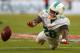 MIAMI GARDENS, FL - SEPTEMBER 22: Lamar Miller #26 of the Miami Dolphins misses a pass during a game against the Atlanta Falcons at Sun Life Stadium on September 22, 2013 in Miami Gardens, Florida. (Photo by Mike Ehrmann/Getty Images)