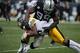 Oct 27, 2013; Oakland, CA, USA; Pittsburgh Steelers wide receiver Antonio Brown (84) is tackled by Oakland Raiders defensive end Lamarr Houston (99) during the third quarter at O.co Coliseum. The Oakland Raiders defeated the Pittsburgh Steelers 21-18. Man