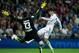 MADRID, SPAIN - SEPTEMBER 28: Alvaro Morata of Real Madrid CF strikes the ball past goalkeeper Thibaut Courtois of Atletico de Madrid during the La Liga match between Real Madrid CF and Club Atletico de Madrid at Estadio Santiago Bernabeu on September 28,