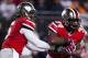 Oct 26, 2013; Columbus, OH, USA; Ohio State Buckeyes quarterback Braxton Miller (5) hands the ball off to running back Carlos Hyde (34) against the Penn State Nittany Lions at Ohio Stadium. Ohio State won 63-14. Mandatory Credit: Greg Bartram-USA TODAY Sp