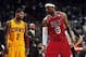 Feb 24, 2013; Miami, FL, USA; Cleveland Cavaliers point guard Kyrie Irving (left) looks over at Miami Heat small forward LeBron James (right) as Cleveland Cavaliers head coach Byron Scott (center) looks on during the second half at the American Airlines A