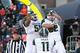 Oct 26, 2013; Champaign, IL, USA; Michigan State Spartans offensive tackle Fou Fonoti (51) tight end Josiah Price (82) and defensive end Jamal Lyles (11) celebrate a touchdown during the second half against the Illinois Fighting Illini at Memorial Stadiu