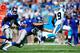 CHARLOTTE, NC - SEPTEMBER 22: Ted Ginn Jr. #19 of the Carolina Panthers high-steps out of a tackle by Justin Trattou #69 of the New York Giants during play at Bank of America Stadium on September 22, 2013 in Charlotte, North Carolina. (Photo by Grant H
