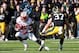 Nov 2, 2013; Iowa City, IA, USA; Wisconsin Badgers running back Melvin Gordon (25) avoids the tackle by John Lowdermilk (37) of the Iowa Hawkeyes at Kinnick Stadium. Wisconsin beat Iowa 28-9. Mandatory Credit: Reese Strickland-USA TODAY Sports