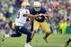 Nov 2, 2013; South Bend, IN, USA; Navy Midshipmen quarterback Keenan Reynolds (19) pitches the ball as Notre Dame Fighting Irish linebacker Romeo Okwara (45) defends in the second quarter at Notre Dame Stadium. Mandatory Credit: Matt Cashore-USA TODAY Spo