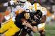 Nov 2, 2013; Columbia, MO, USA; Missouri Tigers offensive linesman Anthony Gatti (70) is tackled by Tennessee Volunteers linebacker Brent Brewer (17) and linebacker A.J. Johnson (45) during the first half of the game at Faurot Field. Mandatory Credit: Den