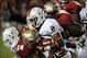 Nov 2, 2013; Tallahassee, FL, USA; Miami Hurricanes running back Duke Johnson (8) is tackled by Florida State Seminoles linebacker Terrance Smith (24) and defensive tackle Timmy Jernigan (8) during the first half at Doak Campbell Stadium. Mandatory Credit