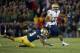 Nov 2, 2013; South Bend, IN, USA; Navy Midshipmen wide receiver Shawn Lynch (87) carries the ball as Notre Dame Fighting Irish safety Eilar Hardy (16) attempts to tackle in the fourth quarter at Notre Dame Stadium. Notre Dame won 38-34. Mandatory Credit: