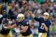 Nov 2, 2013; South Bend, IN, USA; Notre Dame Fighting Irish quarterback Tommy Rees (11) throws for a touchdown in the second quarter against the Navy Midshipmen at Notre Dame Stadium. Mandatory Credit: Matt Cashore-USA TODAY Sports