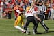 AMES, IA - OCTOBER 26: Quarterback Sam B. Richardson #12 of the Iowa State Cyclones scrambles under pressure from linebacker Caleb Lavey #45 of the Oklahoma State Cowboys in the first half of play at Jack Trice Stadium on October 26, 2013 in Ames, Iowa. (