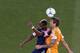HOUSTON, TX - MAY 18: Eric Brunner #2 of the Houston Dynamo plays a ball against Dimitry Imbongo #92 of the New England Revolution in the first half at BBVA Compass Stadium on May 18, 2013 in Houston, Texas. (Photo by Scott Halleran/Getty Images)