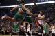 Oct 30, 2013; Toronto, Ontario, CAN; Toronto Raptors guard D.J. Augustin (14) passes the ball as Boston Celtics forward Kris Humphries (43) and forward Brandon Bass (30) defend during the first half at the Air Canada Centre. Mandatory Credit: John E. Soko