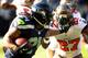 SEATTLE, WA - NOVEMBER 03: Running back Marshawn Lynch #24 of the Seattle Seahawks stiff arms cornerback Johnthan Banks #27 of the Tampa Bay Buccaneers as he runs with the ball during the first quarter of the game at CenturyLink Field on November 3, 2013