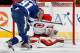 RALEIGH, NC - NOVEMBER 01: Justin Peters #35 of the Carolina Hurricanes deflects the puck wide of the net after blocking a shot from Steven Stamkos #91 of the Tampa Bay Lightning during their NHL game at PNC Arena on November1, 2013 in Raleigh, North Car