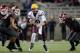 PULLMAN, WA - OCTOBER 31: Taylor Kelly #10 of the Arizona State Sun Devils carries the ball between defenders Ione Gauta #95 and Cyrus Cohen #42 of the Washington State Cougars during the game at Martin Stadium on October 31, 2013 in Pullman, Washington.
