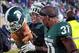 Nov 2, 2013; East Lansing, MI, USA; Michigan State Spartans safety Isaiah Lewis (9) and cornerback Darqueze Dennard (31) walk off the field with the Paul Bunyun trophy during the 2nd half of a game at Spartan Stadium. MSU won 29-6. Mandatory Credit: Mike