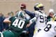 EAST LANSING, MI - NOVEMBER 02: Max Bullough #40 of the Michigan State Spartans closes in on Devin Gardner #98 of the Michigan Wolverines in the first quarter at Spartan Stadium on November 2, 2013 in East Lansing, Michigan. (Photo by Gregory Shamus/Getty