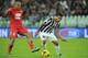 TURIN, ITALY - OCTOBER 30: Carlos Tevez (R) of Juventus in action against Sergio Bernardo Almiron of Calcio Catania during the Serie A match between Juventus and Catania Calcio at Juventus Arena on October 30, 2013 in Turin, Italy. (Photo by Valerio Pen