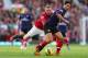 MANCHESTER, ENGLAND - NOVEMBER 03: Wayne Rooney of Manchester United tangles with Mikel Arteta of Arsenal during the Barclays Premier League match between Manchester United and Arsenal at Old Trafford on November 3, 2012 in Manchester, England. (Photo by