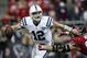 Nov 3, 2013; Houston, TX, USA; Indianapolis Colts quarterback Andrew Luck (12) looks for an open receiver during the second quarter as Houston Texans defensive end J.J. Watt (99) applies pressure at Reliant Stadium. Mandatory Credit: Troy Taormina-USA TOD