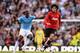 MANCHESTER, ENGLAND - SEPTEMBER 22: Marouane Fellaini of Manchester United evades Yaya Toure of Manchester City during the Barclays Premier League match between Manchester City and Manchester United at the Etihad Stadium on September 22, 2013 in Manchest
