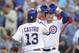 CHICAGO, IL - JULY 9: Anthony Rizzo #44 of the Chicago Cubs (R) waits to congratulate teammate Starlin Castro #13 of the Chicago Cubs at home plate after Castro hit a solo home run during the third inning against the Los Angeles Angels of Anaheim at Wri