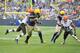 GREEN BAY, WI - OCTOBER 20: Running back Eddie Lacy #27 of the Green Bay Packers (C) is brought down by defensive backs Chris Owens #21 (R) and Tashaun Gipson of the Cleveland Browns after a 13-yard run during the first quarter at Lambeau Field on Octobe