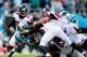 CHARLOTTE, NC - NOVEMBER 03: Paul Worrilow #55 of the Atlanta Falcons tackles Jonathan Stewart #28 of the Carolina Panthers by the facemask but is not called for a penalty during play at Bank of America Stadium on November 3, 2013 in Charlotte, North Car