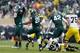 EAST LANSING, MI - NOVEMBER 02: Devin Gardner #98 of the Michigan Wolverines is sacked by Shilique Calhoun #89 of the Michigan State Spartans as teammates Micajah Reynolds #60 and Denicos Allen #28 celebrate in the first quarter at Spartan Stadium on Nov