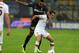MILAN, ITALY - OCTOBER 05: Rolando of FC Inter Milan and Miralem Pjanic of AS Roma (R) compete for the ball during the Serie A match between FC Internazionale Milano and AS Roma at Stadio Giuseppe Meazza on October 5, 2013 in Milan, Italy. (Photo by Cla