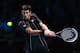 LONDON, ENGLAND - NOVEMBER 07: Novak Djokovic of Serbia hits a backhand in his men's singles match against Juan Martin Del Potro of Argentina during day four of the Barclays ATP World Tour Finals at O2 Arena on November 7, 2013 in London, England. (Phot