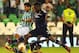 SEVILLE, SPAIN - SEPTEMBER 19: Juanfran (L) of Real Betis Balompie is challenged by Samuel Umtiti and Henri Bedimo (R) of Olympique Lyonnais during the UEFA Europa League group stage match between Real Betis Balompie and Olympique Lyonnais held on Septem
